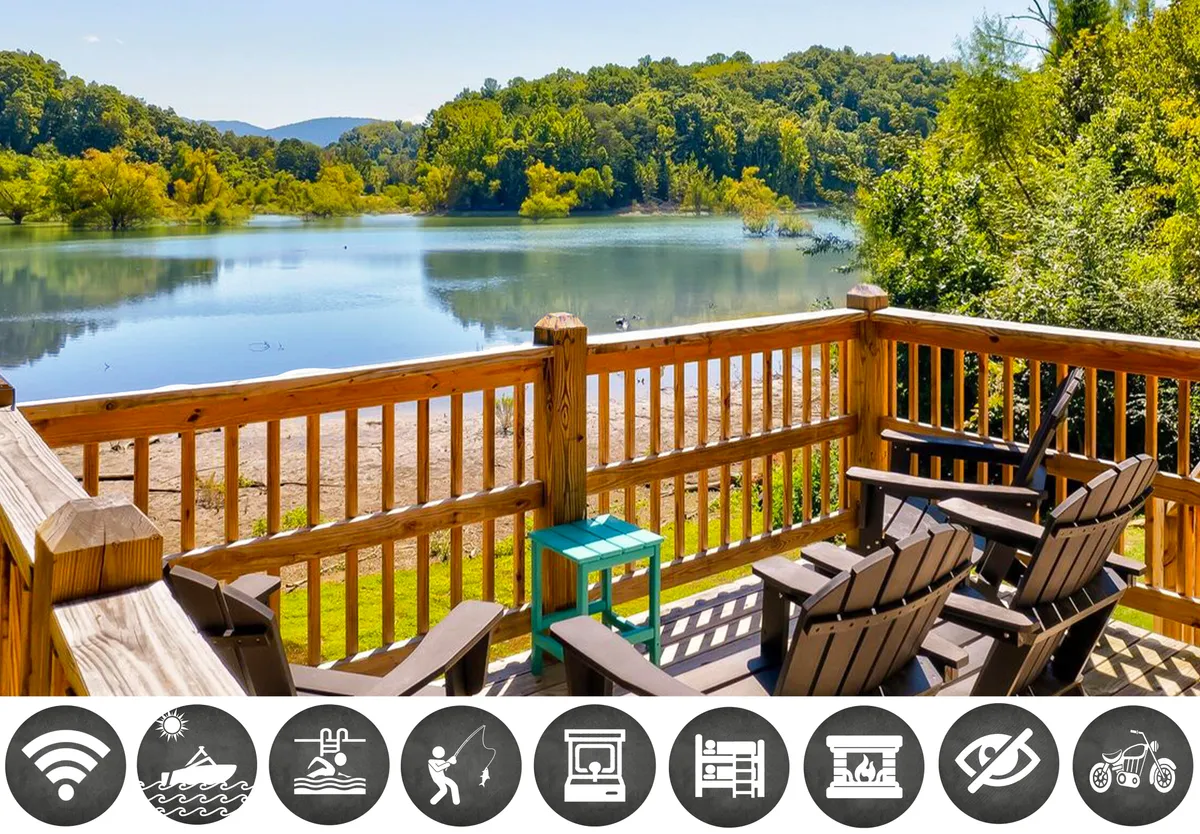The image showcases a spacious wooden deck overlooking the tranquil waters of Douglas Lake, framed by majestic mountain views in the distance. Adirondack chairs are perfectly positioned to take in breathtaking sunsets, promising moments of relaxation and connection with nature.